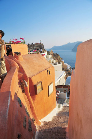 orange houses overlooking the blue sea and mountainsの写真素材