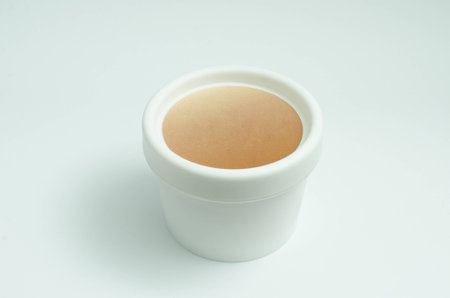 White cream jar isolated on white background. Skin care product package. Opaque beauty face cream container.の写真素材