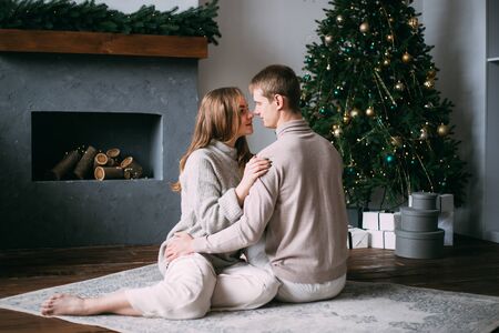 young couple at Christmas time near decorated christmas tree, New Yearの写真素材