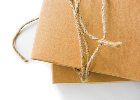 close up shot of brown paper box and string isolated background