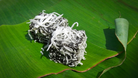 thai dessert called pieak-poon   or black coconut sweet puddingsprinkle with coconut, on banana leafの写真素材