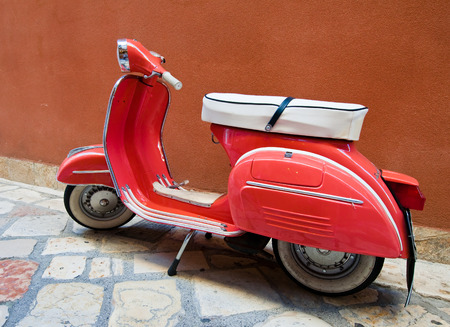 CORFU-AUGUST 22: Vintage Vespa scooter on Kerkyra street on August 22, 2014 on Corfu island. Greece. Vespa is an Italian brand of scooter manufactured by Piaggio.のeditorial素材