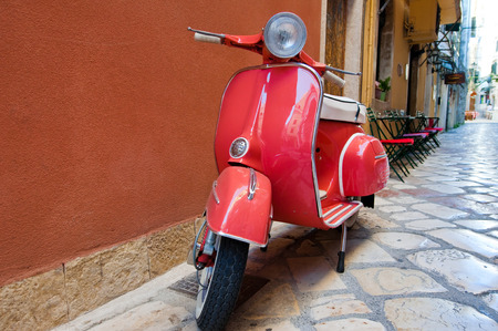 CORFU-AUGUST 22: Classic Vespa scooter on Kerkyra street on August 22, 2014 on Corfu island. Greece. Vespa is an Italian brand of scooter manufactured by Piaggio.のeditorial素材