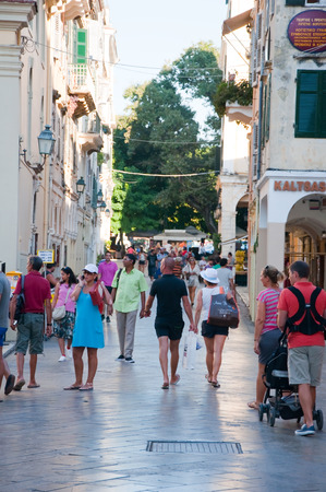 CORFU-AUGUST 27: Kerkyra shadow street in the old town, tourists go shopping on August 27, 2014 on Corfu island, Greece.のeditorial素材