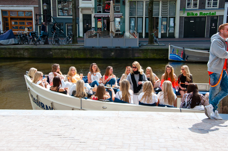 AMSTERDAM NETHERLANDS APRIL 27: Group of girls in a boat celebrate King39s Day on April 272 015 in Amsterdam the Netherlands. King39s Day is the largest openair festivity in Amsterdam.のeditorial素材