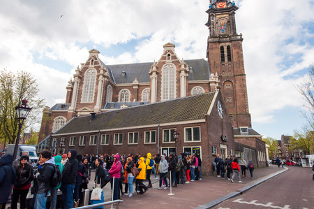 AMSTERDAM-APRIL 30: People and tourists stand in a queue to Anne Frank House Museum on April 30,2015. The Anne Frank House Museum is one of Amsterdam's most popular museums opened in 1960.のeditorial素材