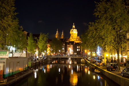 Amsterdam-April 30: Red light district at night, the Church of St. Nicholas is visible in the distance on April 30,2015, the Netherlands.のeditorial素材