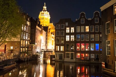 Red light district at night, the Church of St. Nicholas is visible in the distance, the Netherlands.のeditorial素材