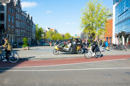 Amsterdam-April 30: Amsterdam downtown, bicycle taxi waits for clients on April 30, 2015, the Netherlands.のeditorial素材