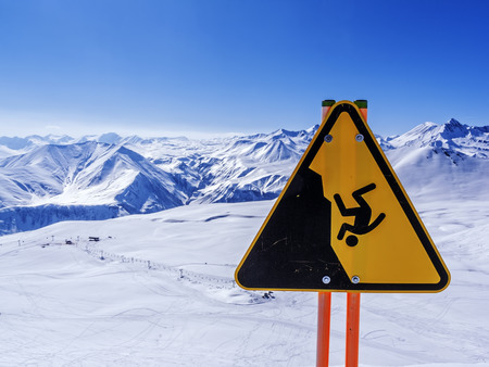 Winter in Greater Caucasus Mountains. Georgia (country). Gudauri ski resort. Hazard and risk sign.の写真素材