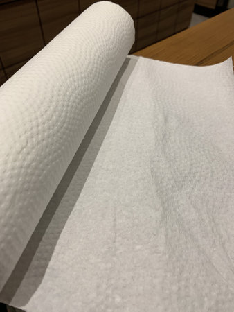 Rolls of white paper on a wooden table in a restaurant.の写真素材