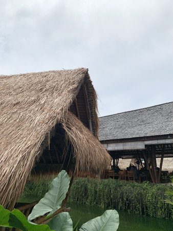 Rattan house with thatched roof in a rural area. Traditional Indonesian house in the river.の写真素材