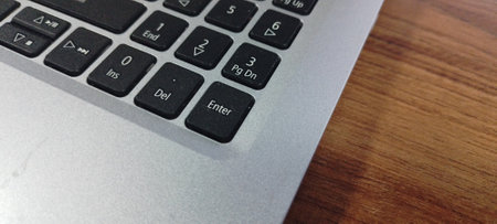 Close up of a black computer keyboard with a white background, Close up of laptop keyboard on wood table background with copy space.の写真素材