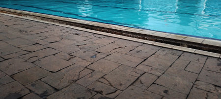 View of the swimming pool, with clean blue water and sun reflections.の写真素材