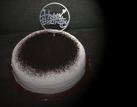 birthday cake with chocolate and cream on a black background, delicious chocolate cake with cream.の写真素材