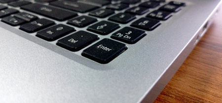 Close up of a black computer keyboard with a white background, Close up of laptop keyboard on wood table background with copy space.の写真素材