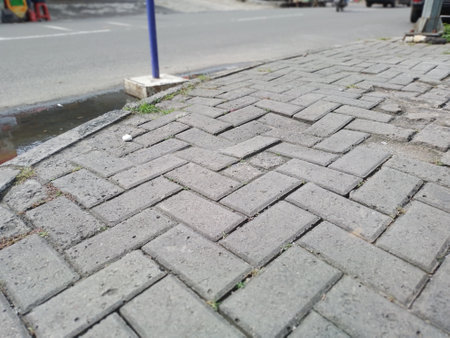 Street pavement with a white background. Cobblestone road in the city, closeup of photoの写真素材