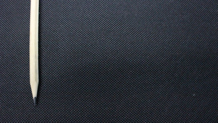 This is a photograph of a Pencil on a textured backgroundの写真素材