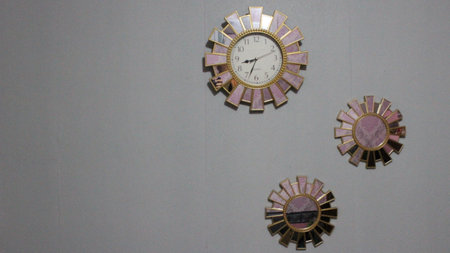 clock in a room with a wall clock on the wall, closeup of photoの写真素材