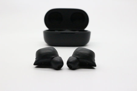 Black earphones with white background.