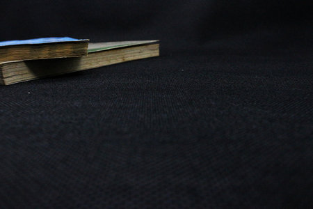 Old book on black background. Back to school. Copy space. Old book on a black background. Back to school, close-up. Education concept. Copy space.の写真素材