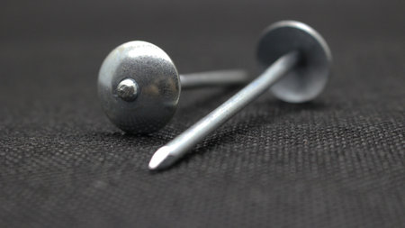 Zinc or asbestos nails. Made of iron with a round head resembling an umbrella. Often called tacks.の写真素材