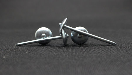 Zinc or asbestos nails. Made of iron with a round head resembling an umbrella. Often called tacks.の写真素材