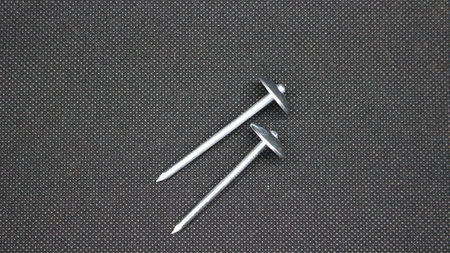 Zinc or asbestos nails. Made of iron with a round head resembling an umbrella. Often called tacks.の写真素材
