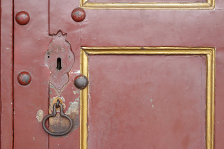 Old brown wooden door in an old building by the roadの写真素材