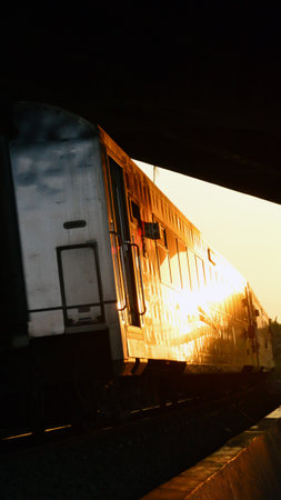 View of the train departing from the station at sunsetのeditorial素材
