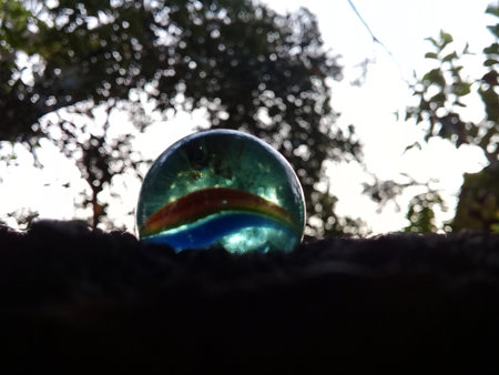 View of toy marbles in backyard with blurred background