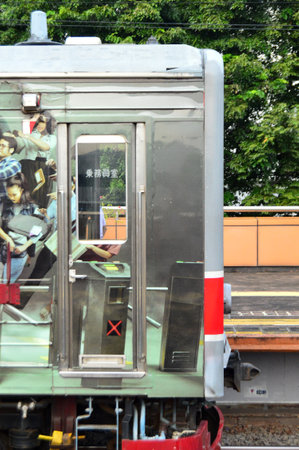 Commuter Line or electric train in Jakarta, Indonesia. In the photo from the right angle, which...