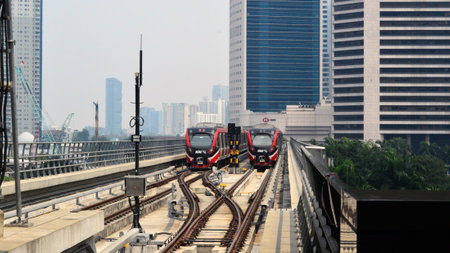 Commuter Line or electric train in Jakarta, Indonesia. In the photo from the right angle, which...