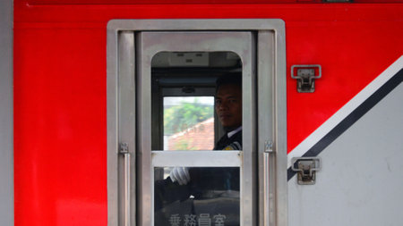 Commuter Line or electric train in Jakarta, Indonesia. In the photo from the right angle, which...