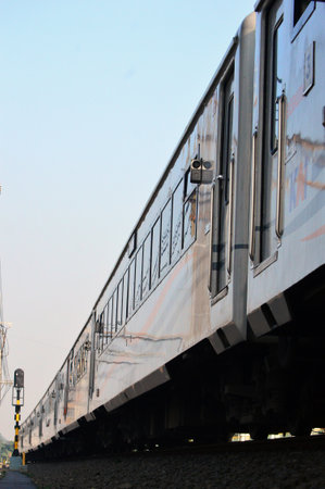 Commuter Line or electric train in Jakarta, Indonesia. In the photo from the right angle, which...
