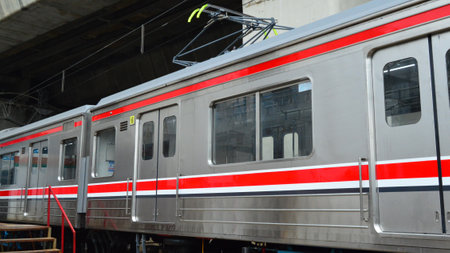 Commuter Line or electric train in Jakarta, Indonesia. In the photo from the right angle, which...