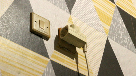 Electrical plugs on the walls of a room.