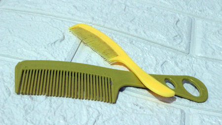Two yellow combs on the floor