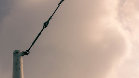 View of the sky decorated with tent poles and ropes, artistic and conceptual. Describes a calm...