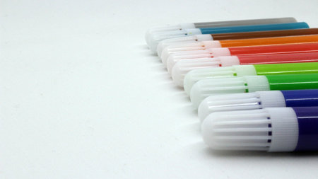Colorful markers in small size, white background.