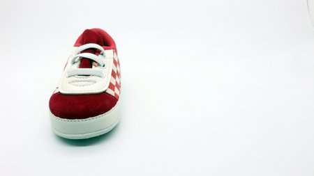 Baby children's shoes in cute red and white colors, white background.の写真素材