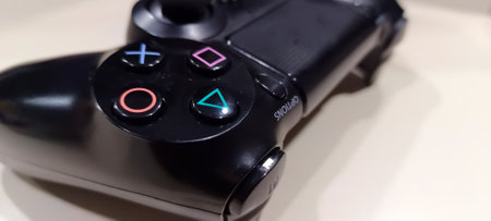 Close Up of a black PS 4 stick on the table