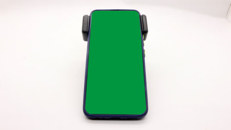 Portrait of a mobile phone with a blue screen, on a white background.の写真素材