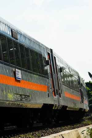 The side view of the train is waiting for passengers at the station during the dayの写真素材