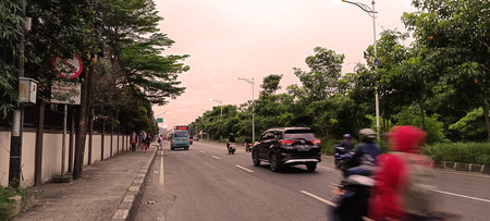 The atmosphere of a highway in the city of Bekasi with motorbikes and carsの写真素材