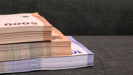 Stack of indonesian currency isolated on black background