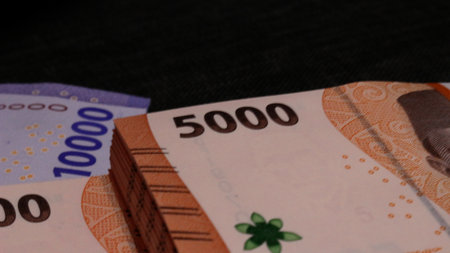 Stack of indonesian currency isolated on black background