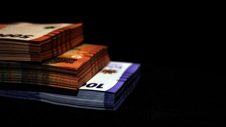 Stack of indonesian currency isolated on black background