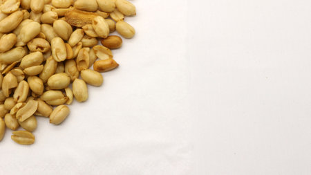 Delicious fried peanuts isolated on white background