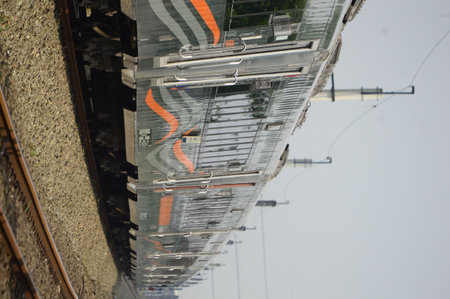 View of a passenger train traveling in a rural area. You can see two train tracks, and this is truly...
